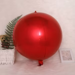 Balon din folie sferic de tip Orbz avand o culoare rosu intens cu un finisaj foarte lucios si o supapa vizibila la baza