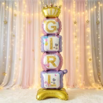 balon folie airwalker girl Balon gigant din folie tip Airwalker, format dintr-o baza aurie, cuburi in nuante pastelate de roz si mov ce formeaza cuvantul GIRL si o coronita regala, integrat intr-un decor festiv.