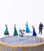 Set 24 Toppere Decorative Toppere Briose Frozen Elsa Un Set De Scobitori Decorative Tip Topper Pentru Briose Si Tort Cu Tematica Frozen. Imaginea Prezinta Sase Personaje Infipte Intr-Un Tort Gri Cu Glazura Aurie