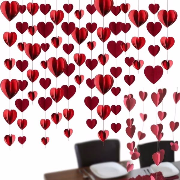 ghirlanda banner inimi rosii Ghirlanda banner inimi rosii cu efect 3D, formata din mai multe siraguri verticale suspendate deasupra unei mese festive, creand un decor romantic si voluminos.