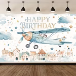 Background Textil Avioane Cod 775B Mockup cu un background textil pentru panou foto cu tematica avioane, ilustrand un satuc pitoresc la baza, un avion vintage albastru zburand deasupra, norisori, stelute si textul Happy Birthday in stil acuarela.