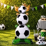 Balon airwalker trofeu fotbal asezat pe iarba verde in cadrul unei petreceri in aer liber cu tematica sportiva alaturi de o masa festiva