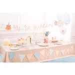 O masa festiva decorata impecabil pentru prima aniversare a unui baietel (My 1st Birthday), incluzand paharele cu romburi, ghirlande, baloane si ursuleti.