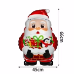 Balon din folie de 66 cm in forma de Mos Craciun iesind dintr-un semineu de caramida, tinand in brate un cadou impachetat festiv si un pinguin simpatic