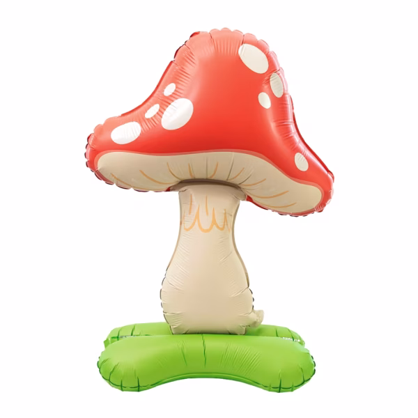 Balon din folie tridimensional de tip standing in forma de ciuperca avand o palarie rosie voluminoasa cu buline albe un picior bej texturat si o baza verde ce imita iarba pentru a sta singur in picioare pe podea