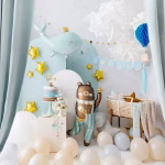 Balon din folie mat in forma de ursulet de plus cafeniu cu ochii inchisi si obraji roz imbracat in pijamale cu dungi albe si bleu tinand in labuta o stea aurie si avand o semiluna aurie imprimata pe burtica