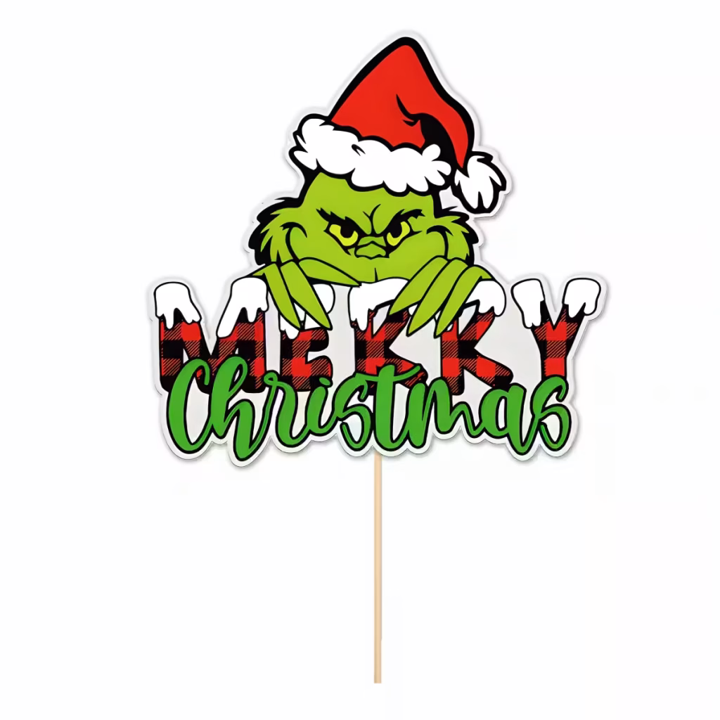 Topper Pentru Tort Din Carton Decupat Pe Contur, Ilustrându-L Pe Faimosul Personaj Verde Grinch Purtând O Căciulă De Moș Crăciun, Privind Furiș Pe Deasupra Mesajului Merry Christmas, Unde Cuvântul Merry Are Un Model În Carouri Roșu Cu Negru Și Zăpadă, Iar Christmas Este Scris Cu Un Font Cursiv Verde